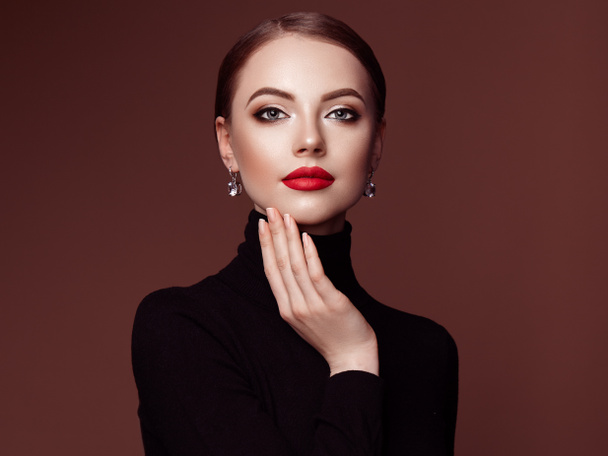 Beautiful Young Woman with Clean Fresh Skin. Perfect Makeup. Beauty Fashion. Red Lips. Cosmetic Eyeshadow. Smooth Hair. Girl in Black Turtleneck - Photo, Image