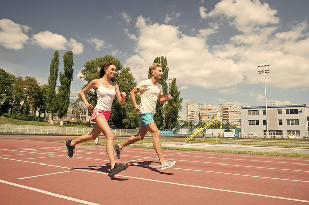 Couple running on arena track. - Photo, image