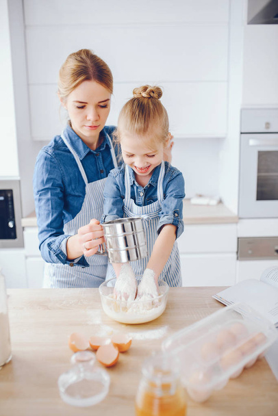 mother with daughter in the kitchen - Photo, image