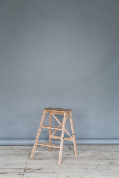 The working space of the photo studio with a grey paper background and chair. - Φωτογραφία, εικόνα