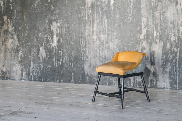 Stool on concrete wall background. Loft room. Wooden floor. daylight. Free space for text. - Фото, зображення