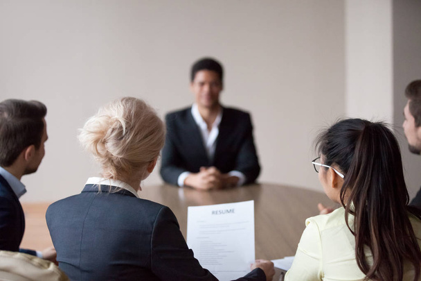 Rear view of hr listening to applicant at job interview - Photo, image