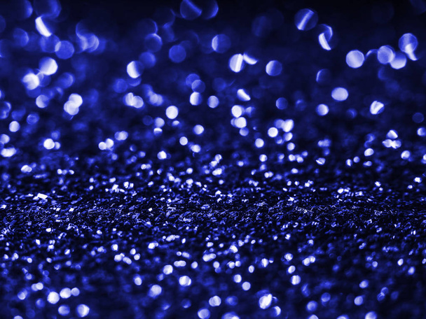 Background sequin. Blue background. Holiday abstract glitter background with blinking lights. Fabric sequins in bright colors. Fashion fabric glitter, sequins. Defocused.  - Photo, Image