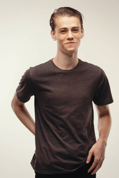 Isolated studio portrait handsome Caucasian male model. laughing at joke, he couldnt stop laughing. Funny friendly looking young boy smiling broadly, cheerful and happy. Dressed in casual t-shirt - Foto, Imagem