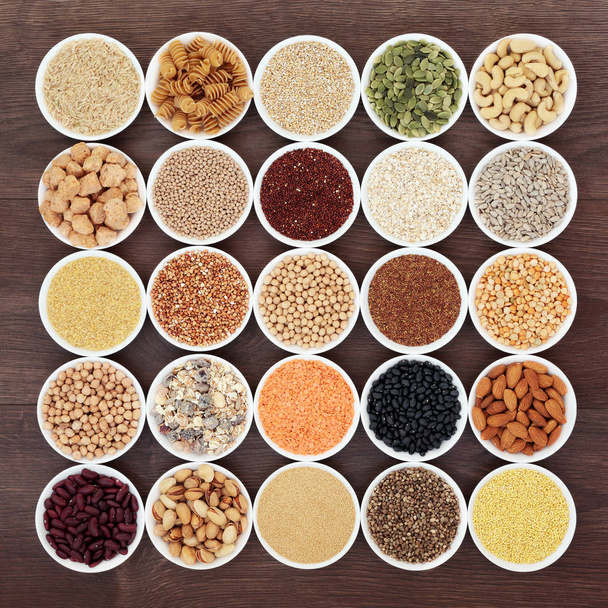 Dried vegan health food with  grains, nuts, seeds, sos mix, cereals, wholegrain pasta and legumes. Super foods high in antioxidants,anthocyanins, protein, vitamins and dietary fibre. - Photo, image