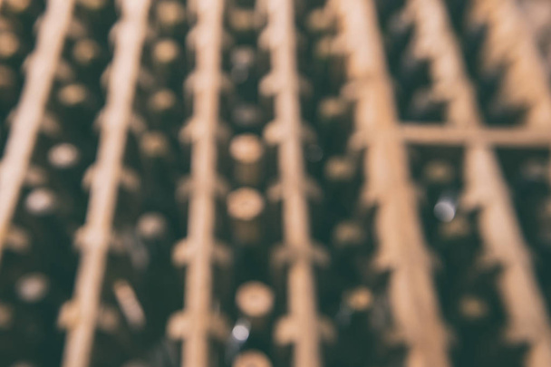 Old wine bottles in the wine cellar, blurred defocused background - Photo, Image