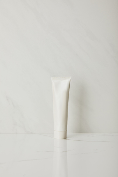 toothpaste in tube on white marble background - Foto, Bild