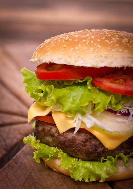 close up view of tasty burger on wooden background - Photo, Image