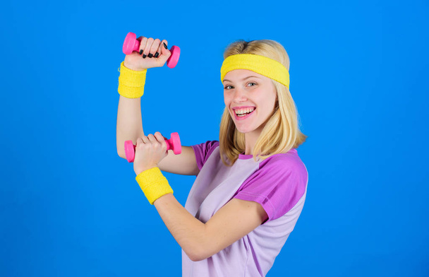 Ultimate upper body workout for women. Fitness instructor hold little dumbbell blue background. Fitness concept. Girl exercising with dumbbell. Workout with dumbbell. Beginner dumbbell exercises - Foto, afbeelding