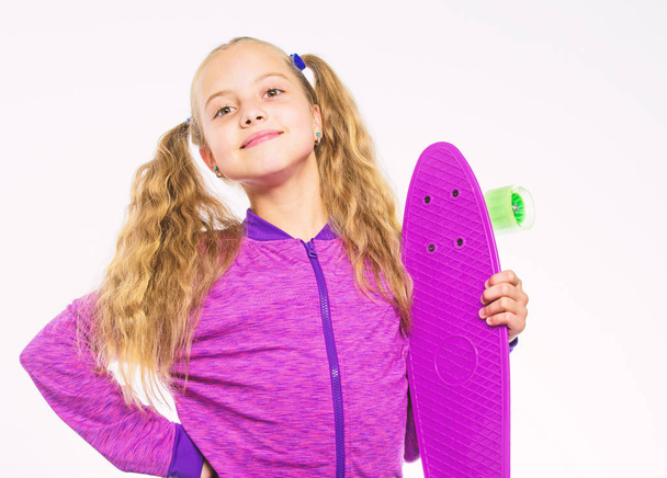 Child hold penny board. Kid long hair carry penny board. Plastic skateboards for everyday skater. Penny board of her dream. Best gifts for kids. Ultimate gift list help pick perfect present for girl - 写真・画像
