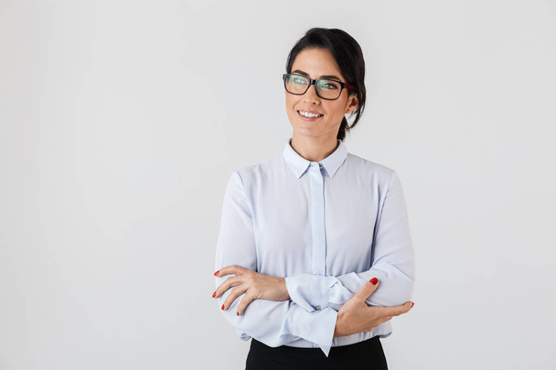 Photo of caucasian businesswoman wearing eyeglasses standing in the office isolated over white background - Zdjęcie, obraz