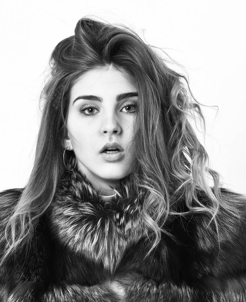 Girl fur coat posing with hairstyle on white background close up. Prevent winter hair damage. Woman makeup calm face hair volume hairstyle. Winter hair care tips you should follow. Hair care concept - Foto, immagini