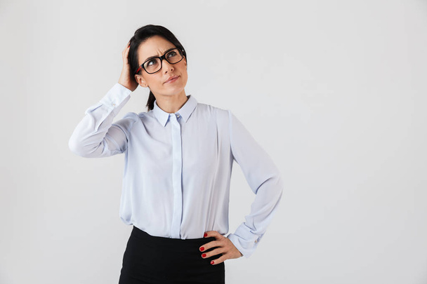 Image of caucasian businesswoman wearing eyeglasses standing in the office isolated over white background - Foto, Bild