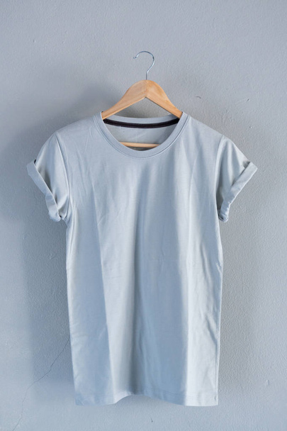 Retro fold blue cotton T-Shirt clothes mock up template on grunge white wood background concept for retail dress shop backdrop, Blank flat lay vintage grey wooden plain laundry advertising - Φωτογραφία, εικόνα