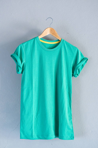 Retro fold green cotton T-Shirt clothes mock up template on gray - Fotó, kép