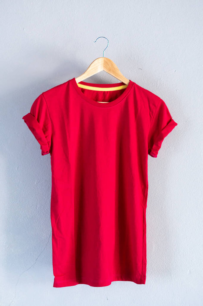 Retro fold red cotton T-Shirt clothes mock up template on grunge white wood background concept for retail dress shop backdrop, Blank flat lay vintage grey wall plain laundry advertising - Foto, Imagem