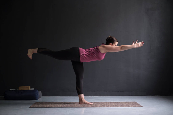 woman practicing yoga, doing Warrior III exercise, Virabhadrasana 3 pose - Foto, Imagen