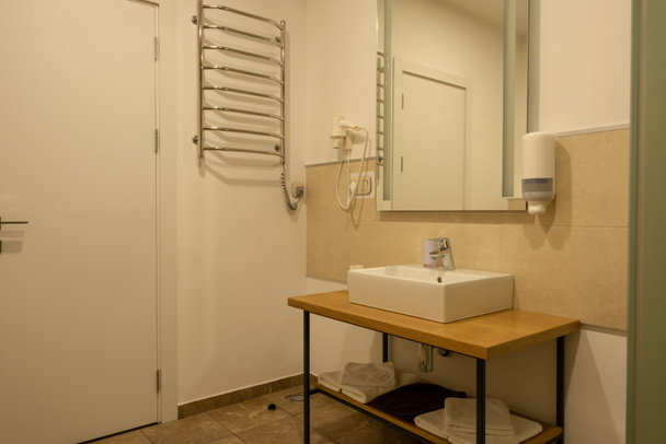 bathroom interior with sink, towels, mirror and hair dryer - Фото, изображение