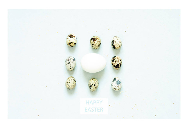 Inscription Happy Easter. Pattern with quail eggs and  feathering on blue background.  - Fotoğraf, Görsel