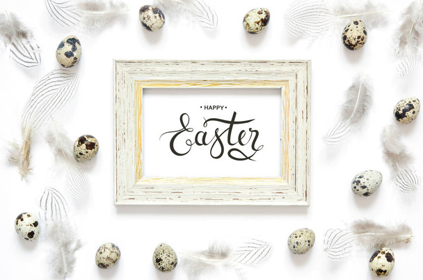 Inscription Happy Easter. Frame with easter eggs and feathers.  - Фото, изображение