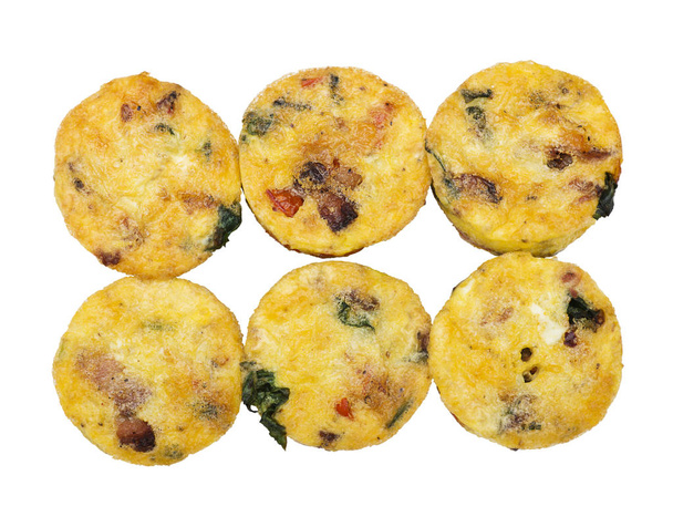 Egg muffins with spinach, bacon, cheese and tomatoes isolated on white - Photo, Image