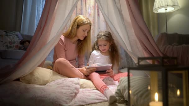 Happy loving family. Young mother and her daughter having fun using tablet playing apps. Slow motion - Filmmaterial, Video