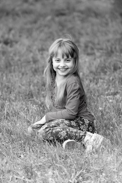 Kid smile on green grass, spring. black and white - Valokuva, kuva