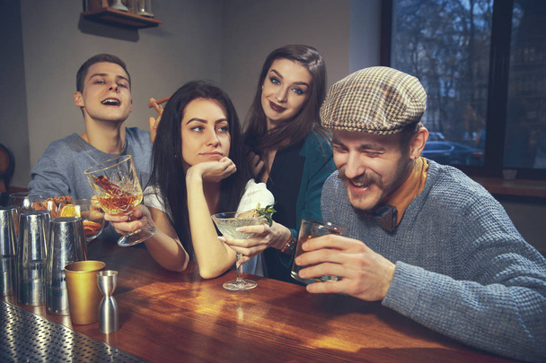 Photo of joyful friends in the bar communicating with each other - Valokuva, kuva