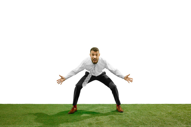 Full length shot of a young businessman playing football isolated on white background - Zdjęcie, obraz