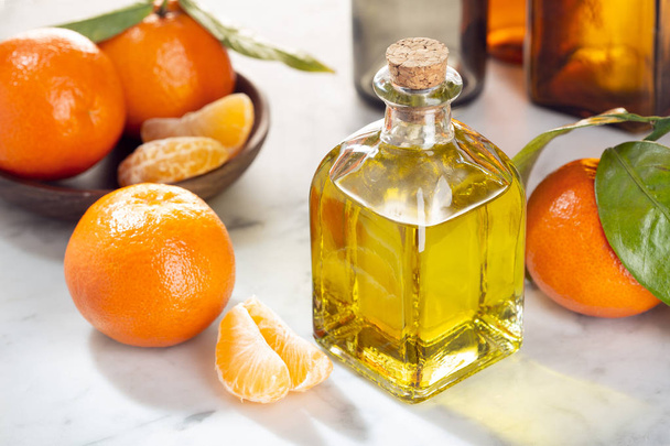 Tangerine essential oil. Mandarin Orange oil for skin care, spa, wellness, massage, aromatherapy and natural medicine. Citrus oil - Zdjęcie, obraz