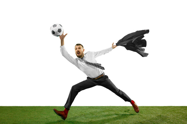 Full length shot of a young businessman playing football isolated on white background - Fotó, kép