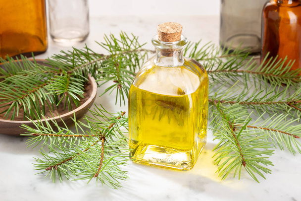 Pine essential oil. Pine oil glass bottle for beauty, skin care, wellness. Alternative medicine - 写真・画像
