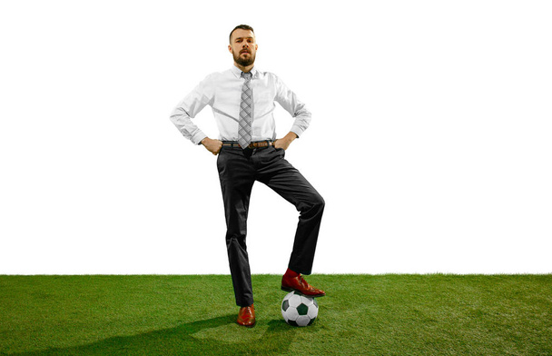 Full length shot of a young businessman playing football isolated on white background - Foto, Bild