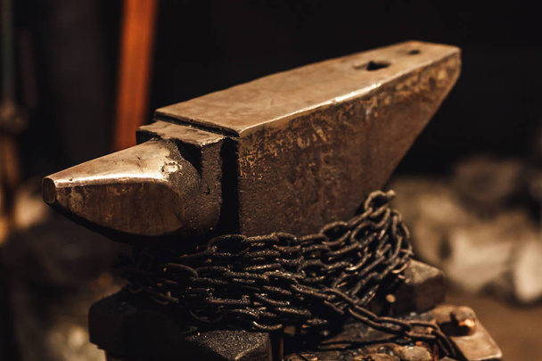 Close-up a blacksmith anvil with wound chain. - Photo, Image