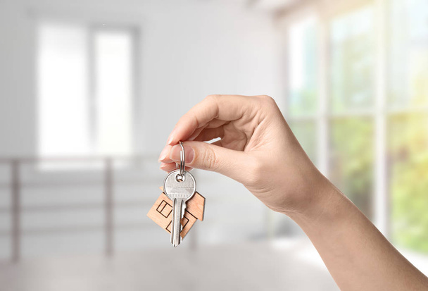 Frau hält Hausschlüssel in moderner Wohnung, Nahaufnahme - Foto, Bild