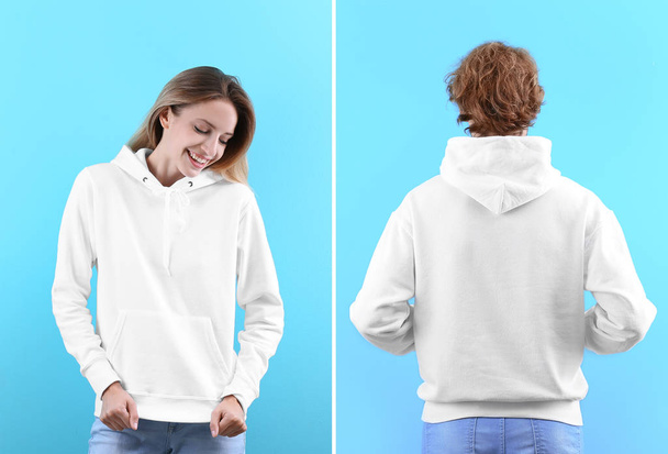 People in blank hoodie sweaters on color background, front and back views. Mock up for desing - Fotó, kép
