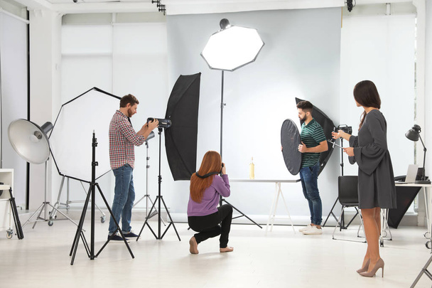 Photo studio with professional equipment and team of workers - Foto, Imagen