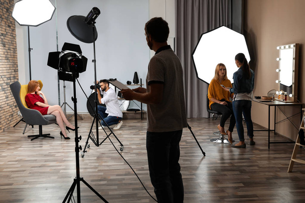 Photo studio with professional equipment and team of workers - Foto, Imagem