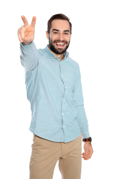 Young man celebrating victory on white background - Foto, Imagen