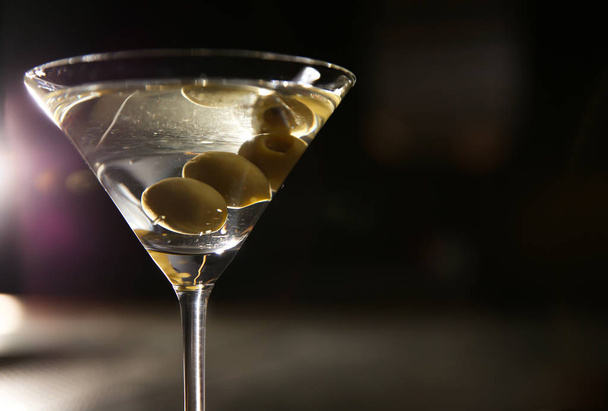 Glass of martini with olives in bar, closeup. Space for text - Foto, imagen