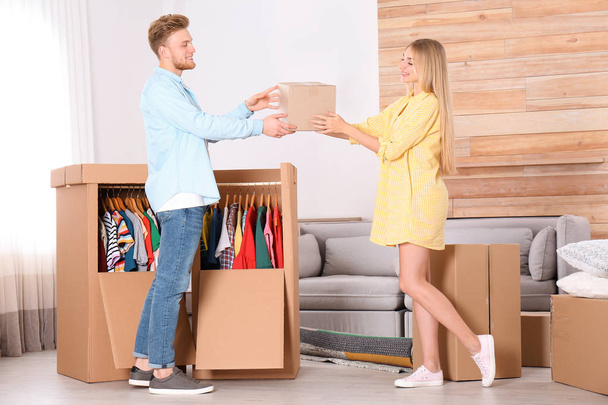 Young couple near wardrobe boxes at home - Photo, image