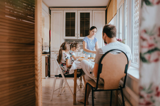 Family breakfast at home in the nice cozy kitchen - Fotoğraf, Görsel