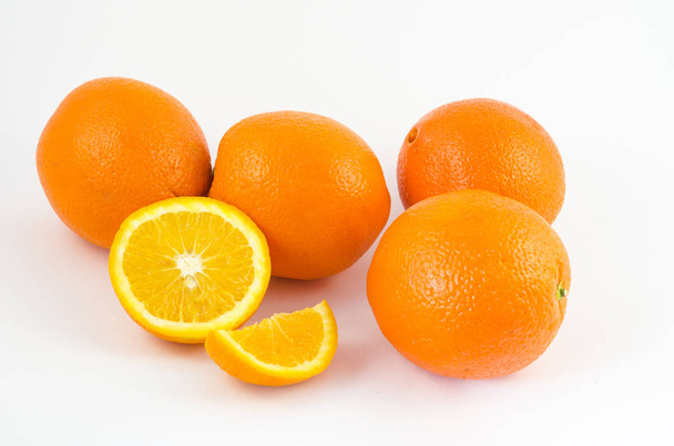 Narancs-fehér háttéren, lédús narancs gyümölcsök. Hasznos az egészséges táplálkozás, trópusi citrusfélék. - Fotó, kép