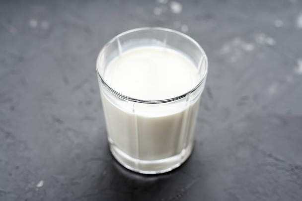 primer plano de la leche en taza de vidrio sobre fondo gris. Productos lácteos
 - Foto, Imagen