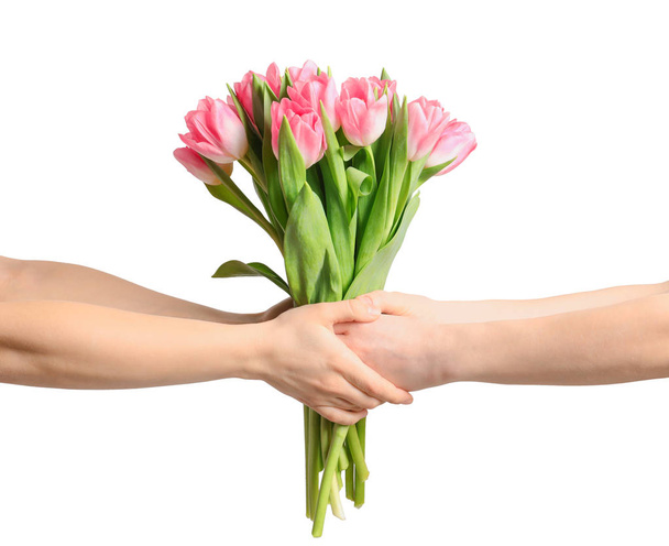 Man and lady holding bouquet of beautiful spring tulips on light background, closeup. International Women's Day - Foto, immagini