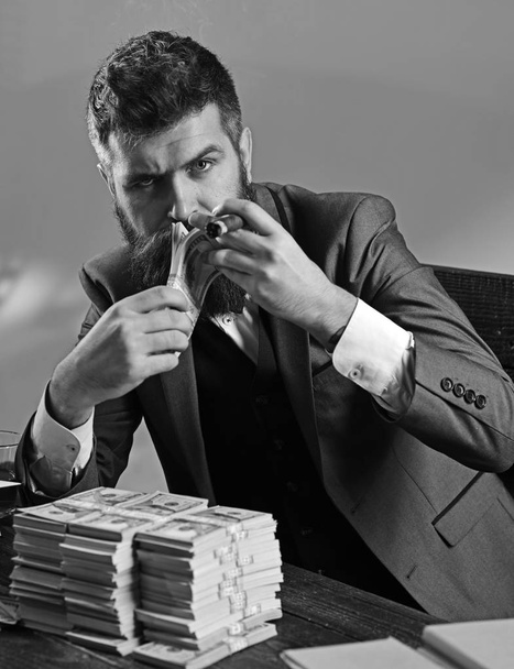 Money and power. Business and finance. Bearded man count dollars while smoking cigar. Successful businessman hold cash money. Rich man with beard in formal wear. Growing a business - Фото, зображення