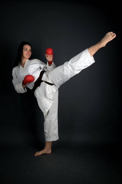 junge Frau in traditionellem Kimono beim Üben ihrer Karate-Bewegungen - Foto, Bild
