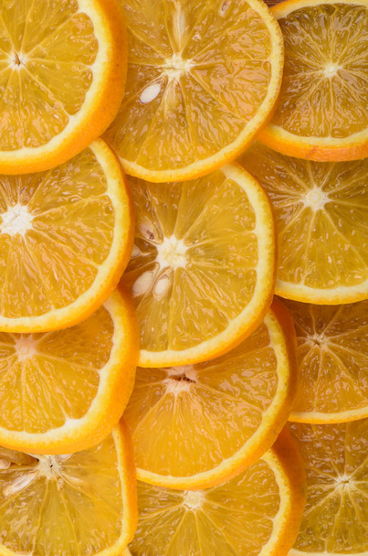 Background of ripe juicy orange slices. The texture of orange. Vertical - Foto, imagen