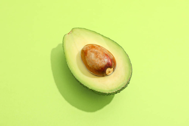 Half of avocado on color background, space for text - Photo, Image