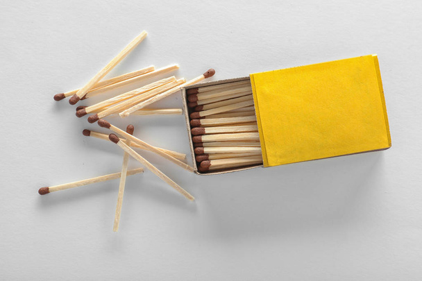 Cardboard box and matches on white background, top view. Space for design - Foto, afbeelding